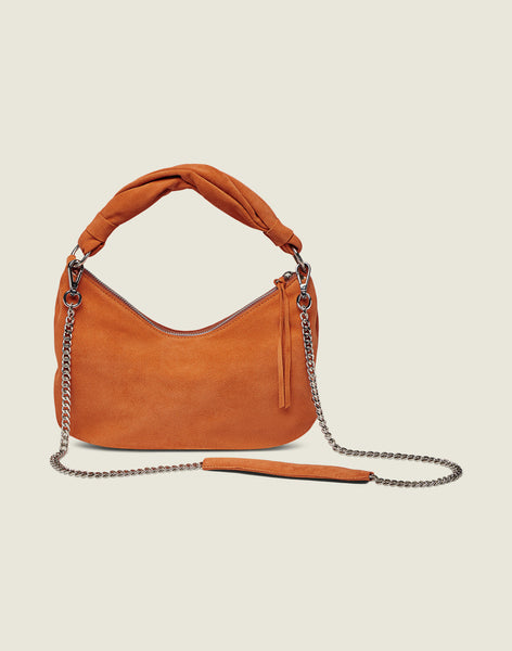 Front shot of the Crescent Bag in Apricot with chain