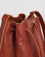 Handle shot of Mini Hammered Stud Bucket Bag in Saddle