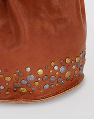 Stud Detail shot of Mini Hammered Stud Bucket Bag in Saddle