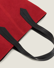 LEATHER HANDLE SHOT OF THE TAB TOTE IN RED SUEDE