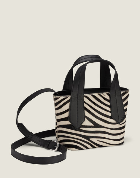 Front shot of Tab Tote Mini in Zebra Haircalf featuring the removable leather strap