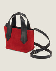 SIDE SHOT OF THE TAB TOTE MINI IN RED SUEDE AND LEATHER CROSSBODY STRAP