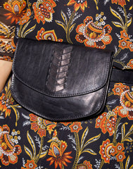Detail of model shot wearing Laced Up Leather Belt Bag in Black